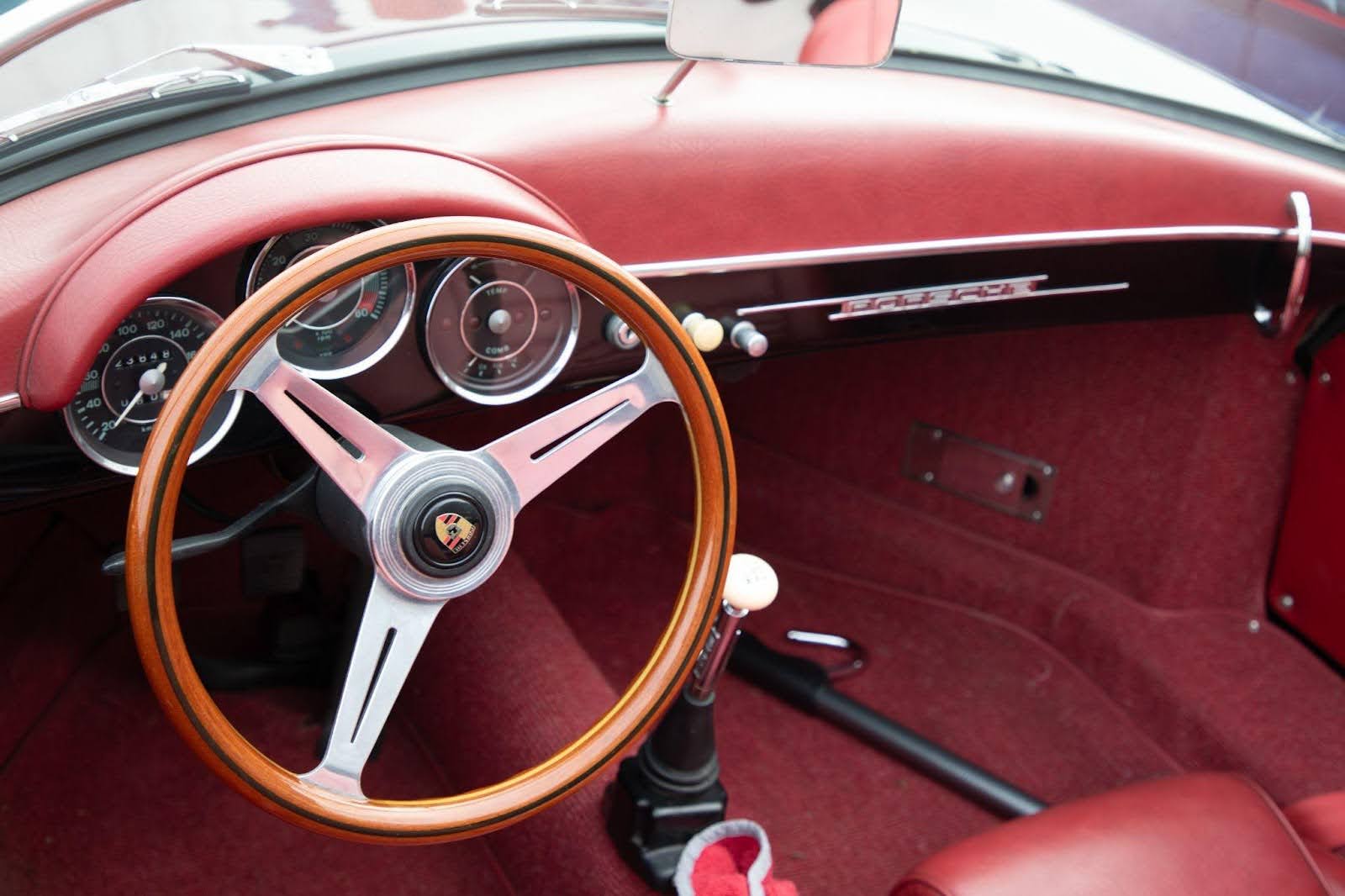 Classic car interior highlighting the detailed steering wheel and retro dashboard