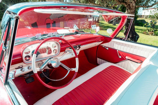 Classic car interior showcasing stylish red and white trim highlighting vintage design elements