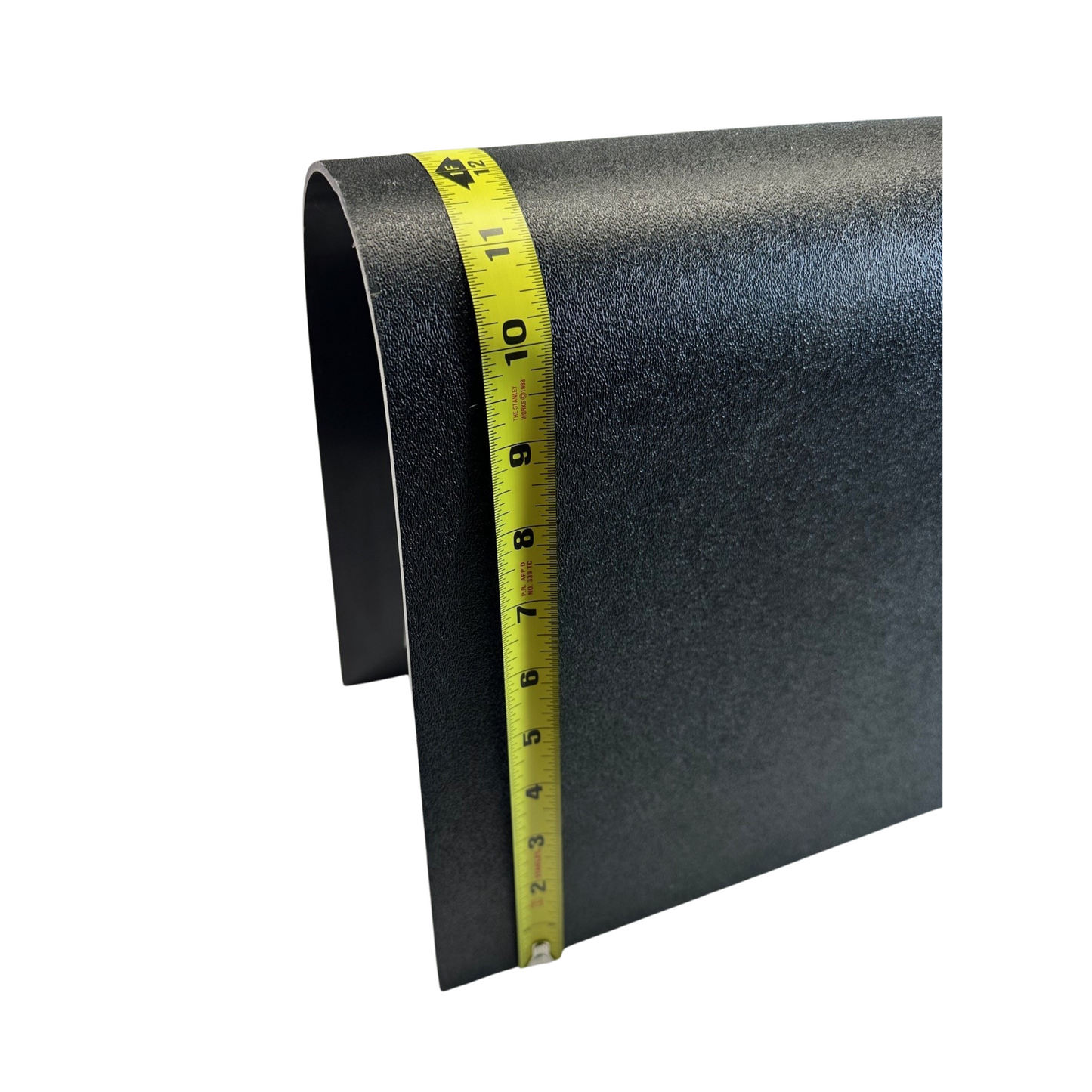 Black sandpaper with a yellow measuring tape on a white background