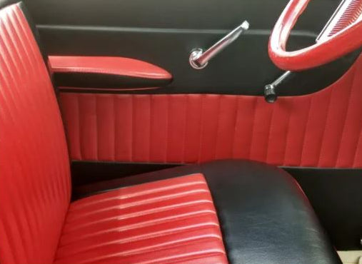 Close-up of a car's red and black interior, focusing on the seat and door panel.