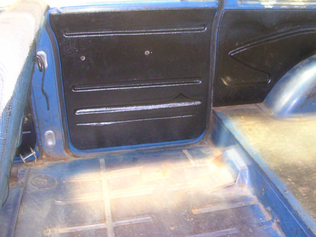 ABS quarter panels installed in rear cabin bed area, black finish shown against blue truck interior