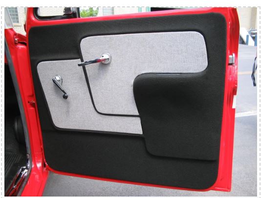Car door panel with gray and black materials on a red car.