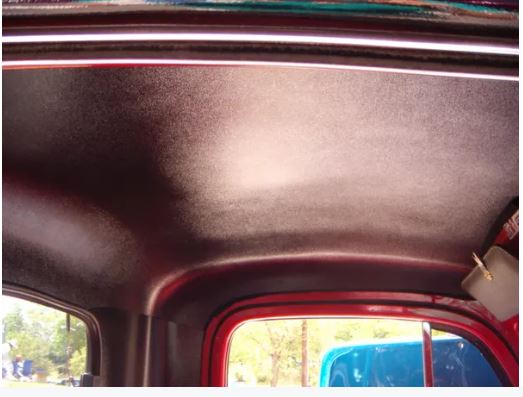 Interior roof of a 1951-1952 Ford truck with a black headliner and visible quarter panels.