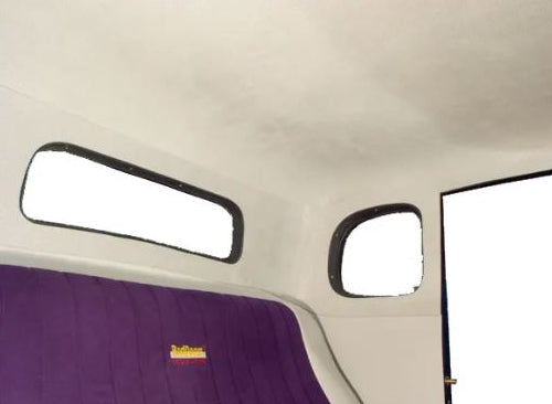 A photo showing a car headliner with quarter panels, primarily in a solid white color with a visible purple fabric detail.