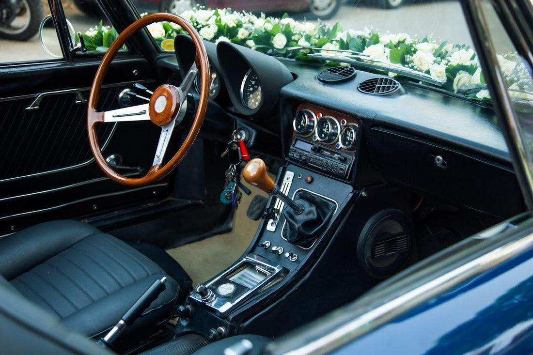 The interior of a classic car adorned with colorful flowers creating a vibrant and nostalgic atmosphere
