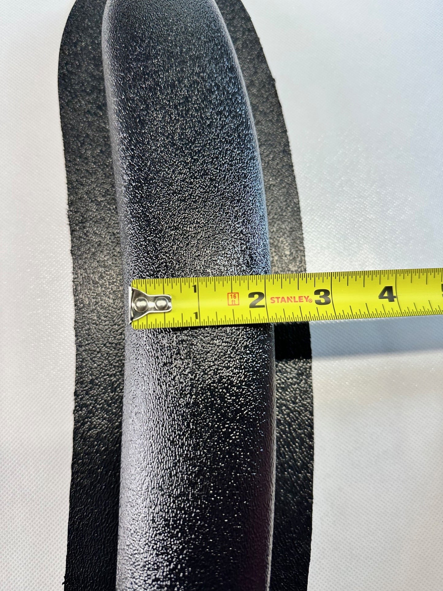 Close-up of universal modular ABS armrest side profile with measuring tape showing length measurement