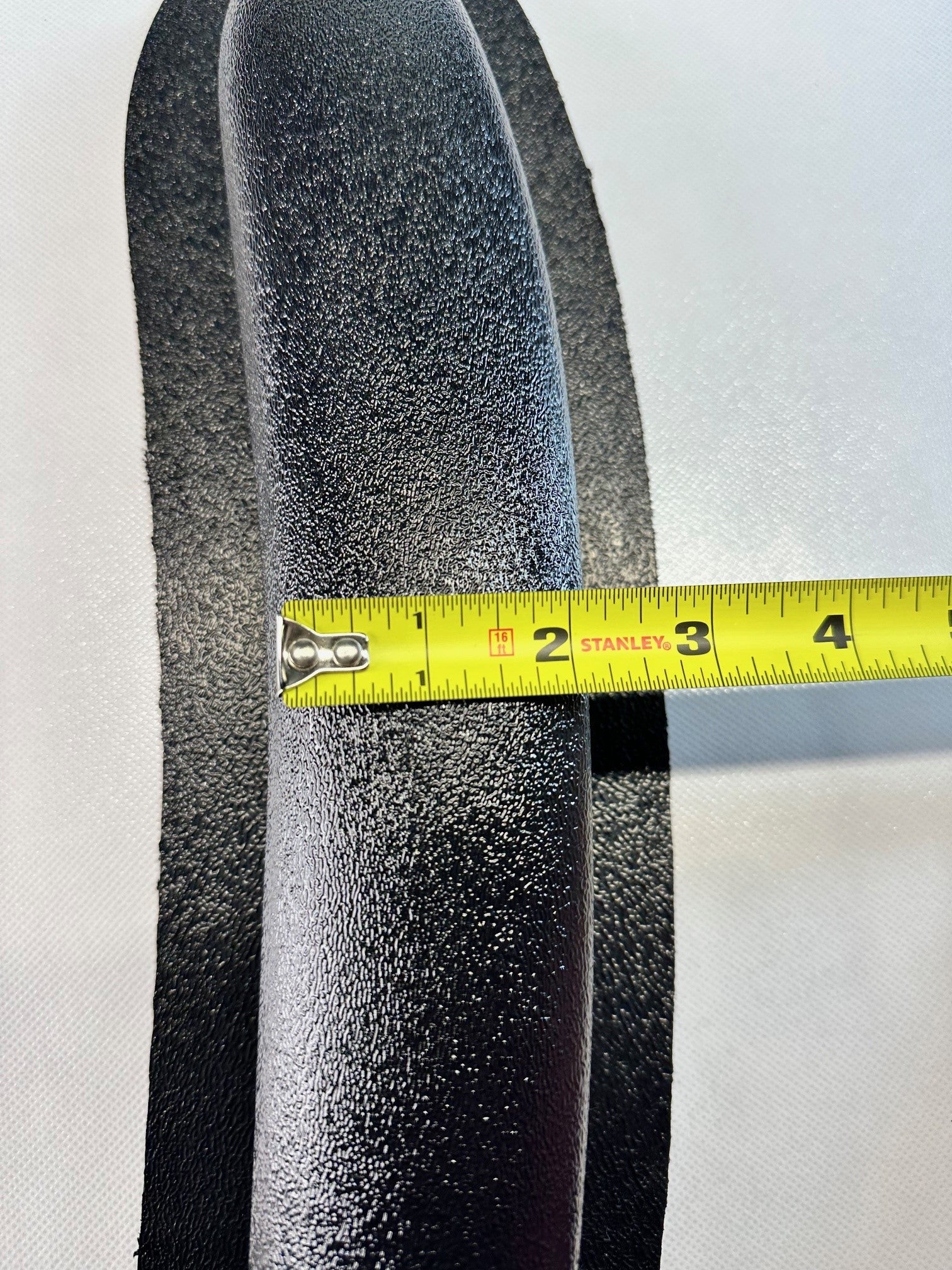 Close-up of universal modular ABS armrest side profile with measuring tape showing length measurement