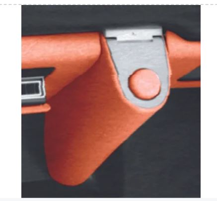 Close-up of a red leather strap with a metal buckle on a dark background.