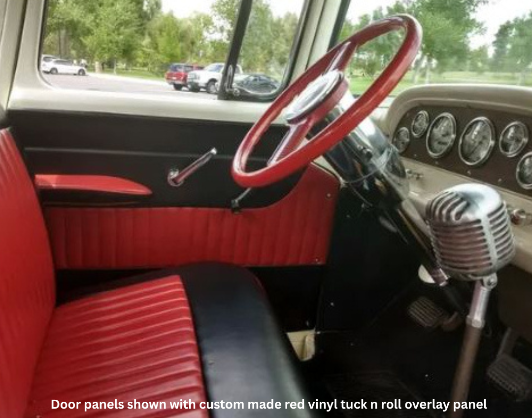 Vintage car interior with red steering wheel and seats, dashboard, and door panels.