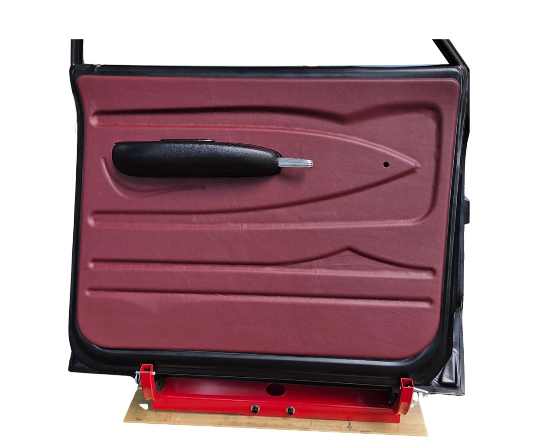 Red car door panel on a stand with text about material type.