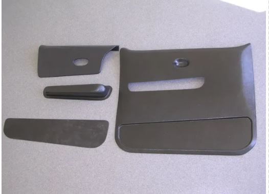 A set of four black door panels with armrests for 1973-1979 Chevrolet trucks, displayed on a white background.