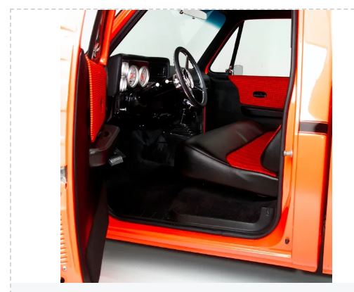 Interior of a red vehicle with black seats.