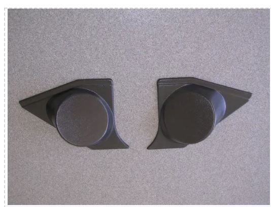 Two black plastic components on a gray background