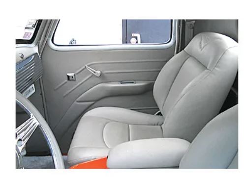 An interior showing white 1947–1955 Chevrolet truck Eureka‑style ABS door panels by Rod Doors installed on a vehicle's interior, featuring a simple solid color design.