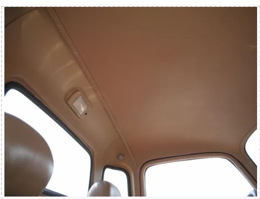 Beige car interior with a sun visor and window