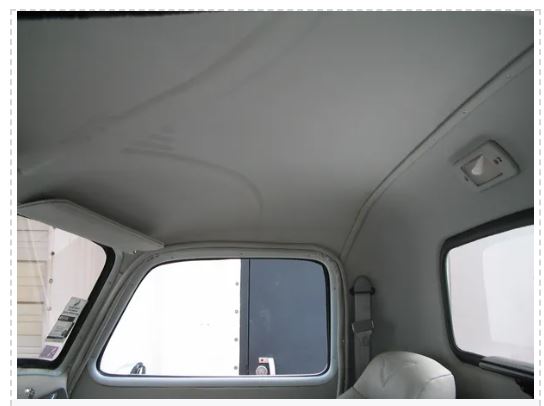 Car interior with a focus on the ceiling and window