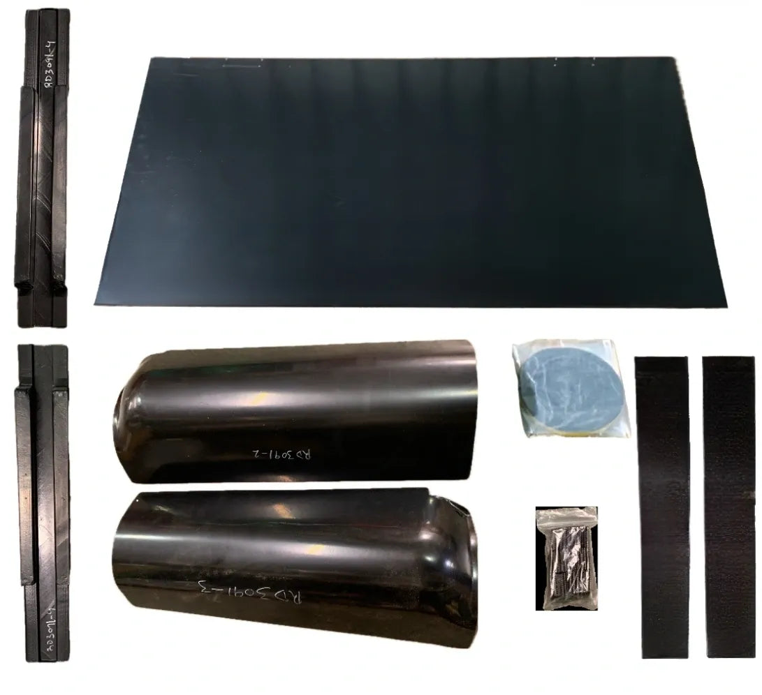 A collection of parts for a rear cab cover, including a large flat black piece and smaller black components, possibly for a 1949-1955 Chevrolet Truck.