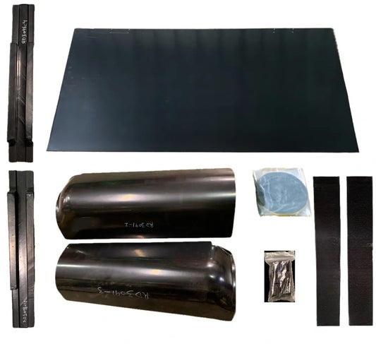 A collection of parts for a rear cab cover, including a large flat black piece and smaller black components, possibly for a 1949-1955 Chevrolet Truck.