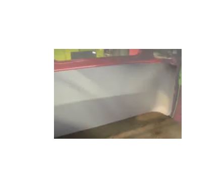 White wall with a colorful object on top, possibly a piece of furniture or decor.