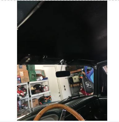 Car interior with a view of a garage.