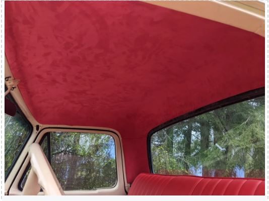 Red car interior with a view of trees outside