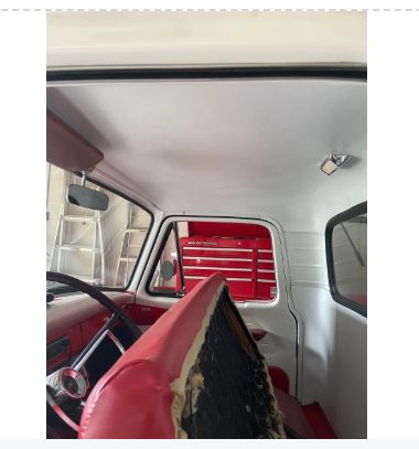 Interior of a vehicle with red tool box on the dashboard