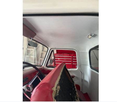 Interior of a classic vehicle with red and white interior