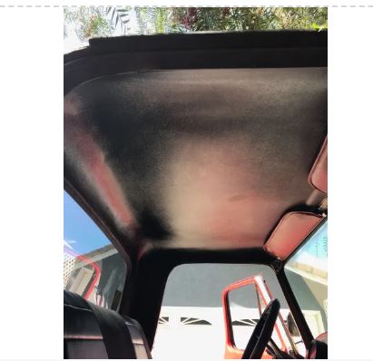 Car interior with a sunshade covering the windshield