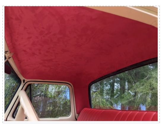 Red car interior with a view of trees outside