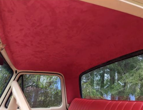 Red car interior with a view of trees outside