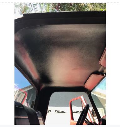 Car interior with a sunshade covering the windshield