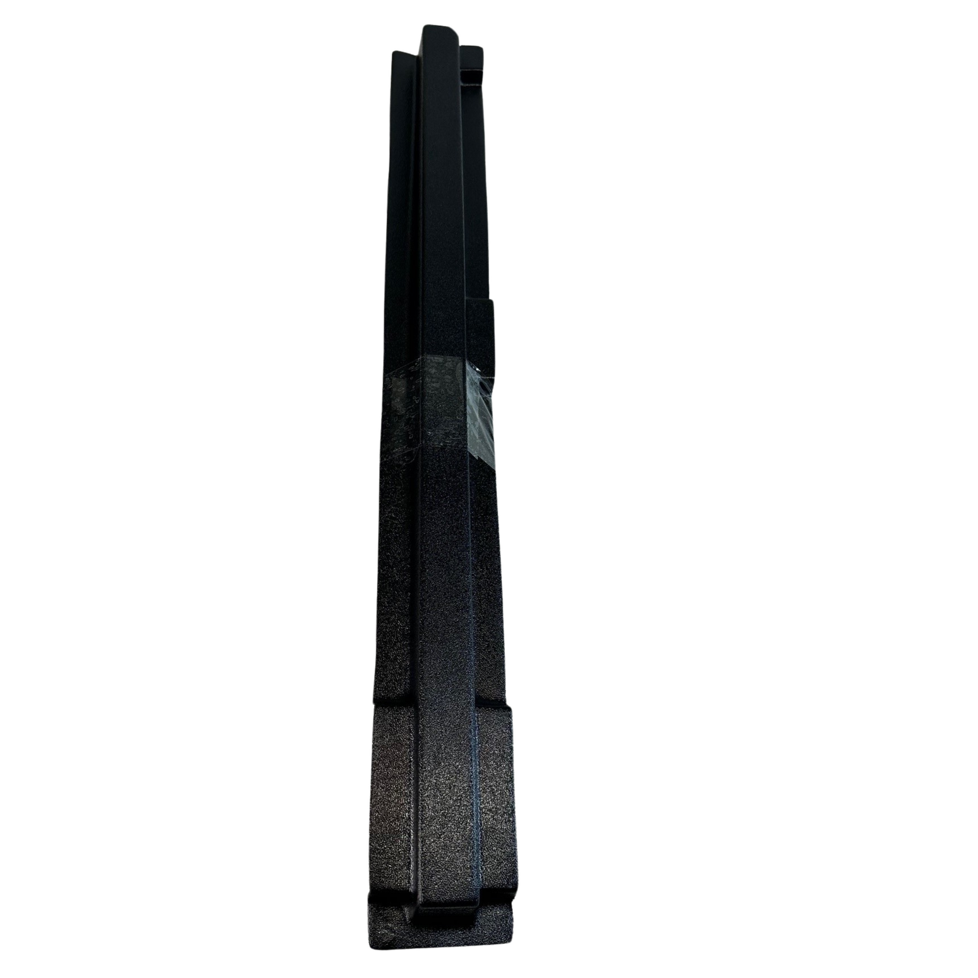Black rectangular object with textured surface on a white background