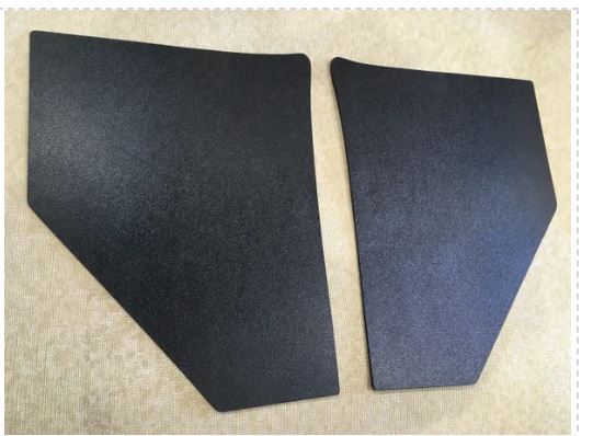 Two black soundproofing panels on a beige background