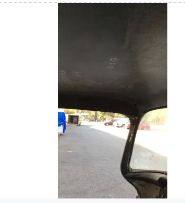 A black headliner for a 1955-1959 Chevrolet Truck, showing the material texture and the beginning of the frame attachment points