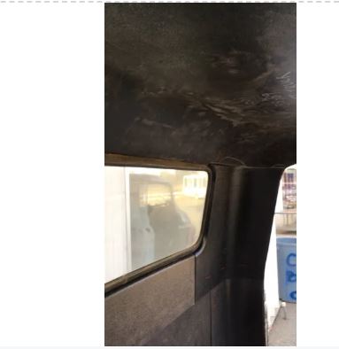 Close-up of an installed black headliner in 1955–1959 Chevrolet truck