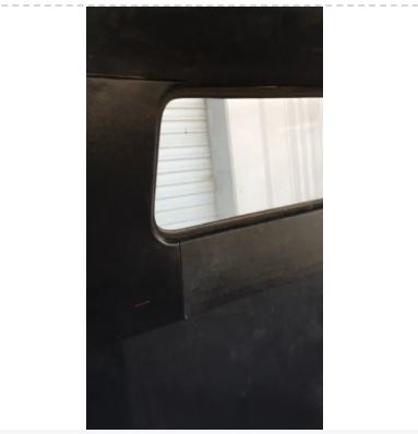 Close-up of a black car seat with a reflective surface