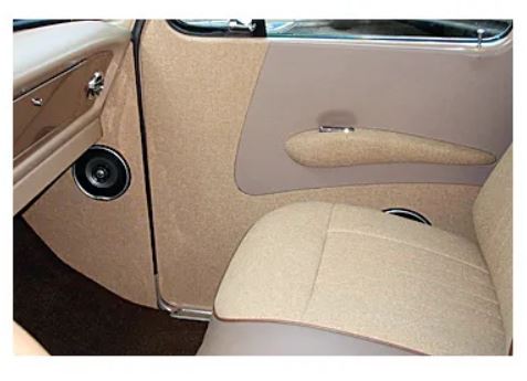 A photo showing a pair of beige door panels with armrests for 1967-1972 Ford Trucks, installed in a vehicle interior.