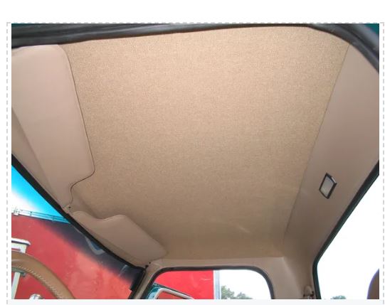 Beige headliner installed inside the interior of a vehicle, likely made from ABS plastic.