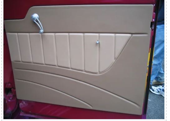 Beige car door panel on a red surface