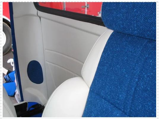 Car interior with blue seat covers and a red exterior.