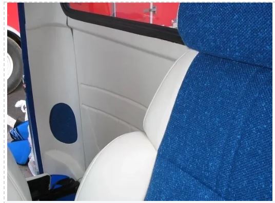 Car interior with blue seat covers and a red exterior.