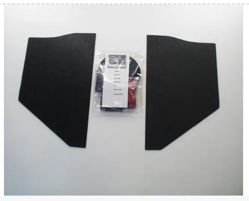 Two black car interior panels with a small package in the center on a white background