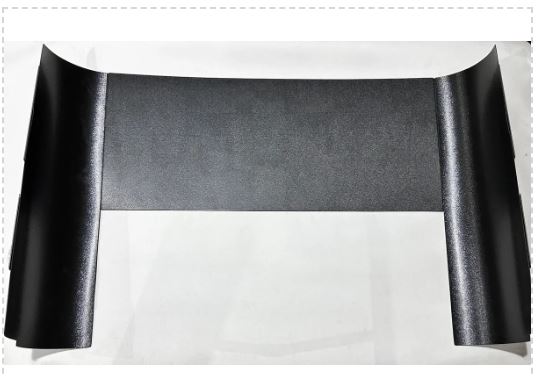 Black textured paper or cardboard with a glossy finish.