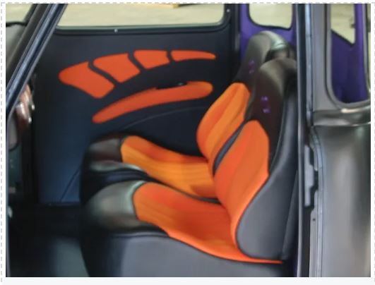 Car seat with orange and black pattern inside a vehicle