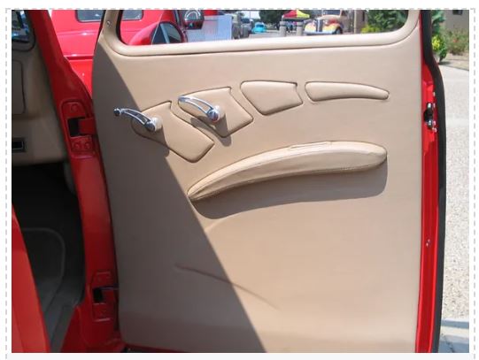 Beige car door panel with red car exterior in the background