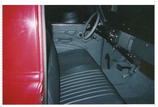Close-up of a car interior with a red door panel.