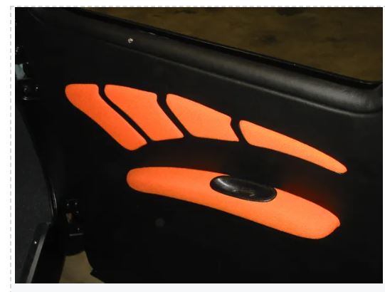 Black vehicle door with orange reflective stripes and a handle