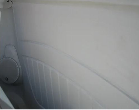 Close-up of a car's interior door panel with a visible air vent.