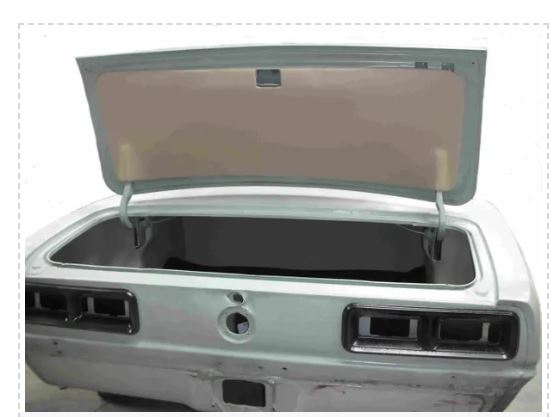 Open trunk of a car with a gray cover.