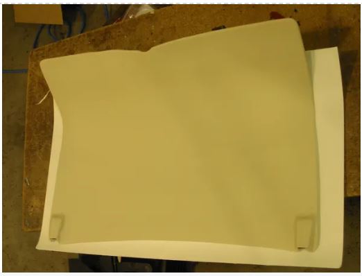 Beige paper or cardstock on a wooden surface.